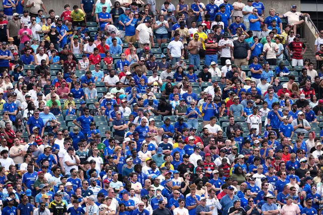 Chelsea fans sit and watch on in the stands