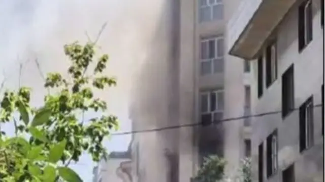 Smoke issuing from a street corner in Tehran