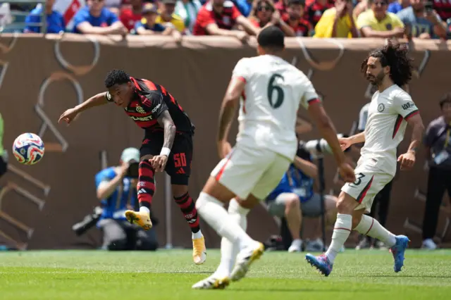 Plata fires at goal under pressure from two defenders