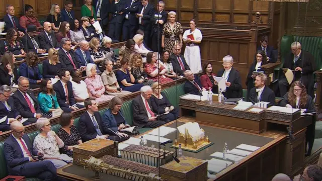 Inside the House of Commons, MPS sat on seats.