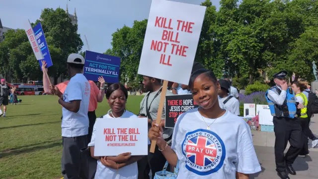 Beatrice holds a placard reading kill the bil, not the ill