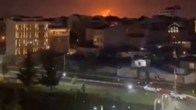 A screengrab from footage taken in Rasht, Iran, showing an explosion on the horizon