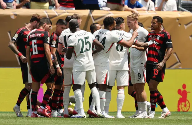 Players from both teams shove each other as they argue a decision