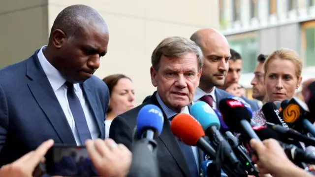 David Lammy and several others speak into microphones