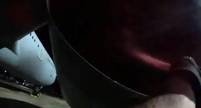 Still image showing red liquid being sprayed into turbine engine