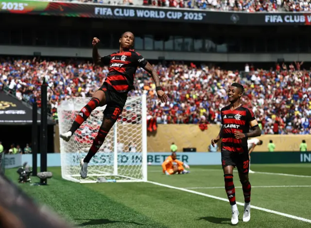 Yan celebrates his goal by leaping and punching the air