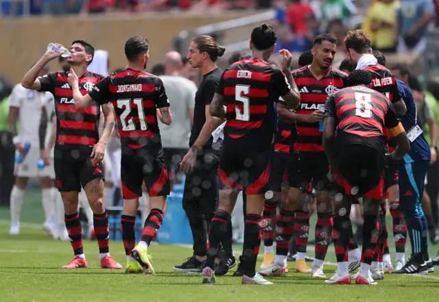 Players take on fluids during a cooling break