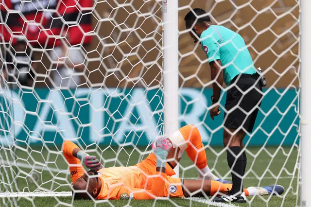 Sanchez lies stricken in his net after colliding with the post