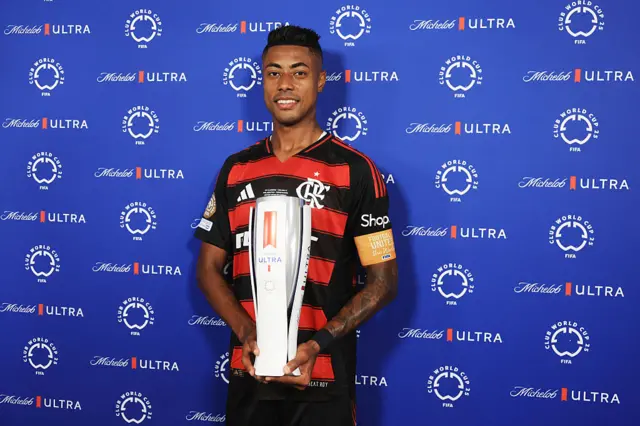 Bruno Henrique named player of the match and poses with trophy