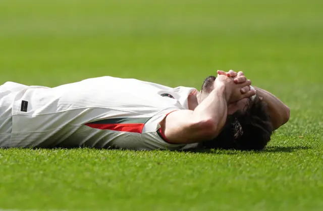 Neto lies on the floor at full time
