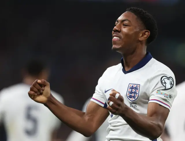 Myles Lewis-Skelly celebrates scoring for England