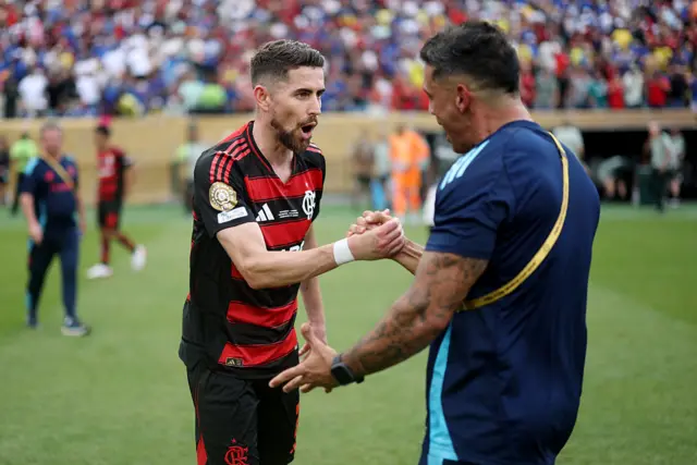 Jorginho celebrates with one of the backroom staff