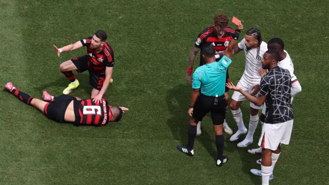 Jackson is sent off as a Flamengo player rolls on the floor after his high challenge