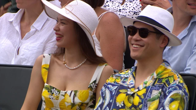 Two fans smile while wearing shirts featuring a number of lemons