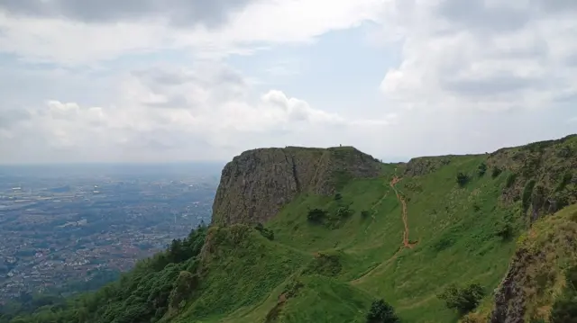The edge of a cliff overlooking a valley