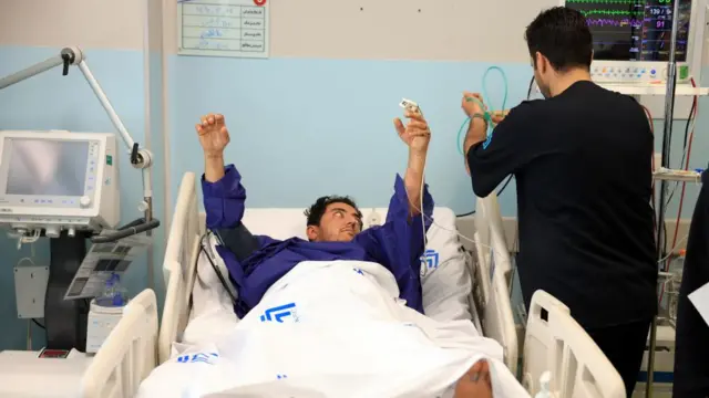 An Iranian man is treated at the Imam Khomeini hospital after Israeli airstrikes in Tehran.