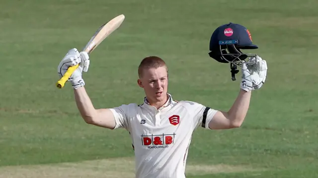 Charlie Allison of Essex raises his bat after reaching his century