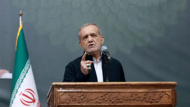 Iranian President Masoud Pezeshkian speaks behind a podium.