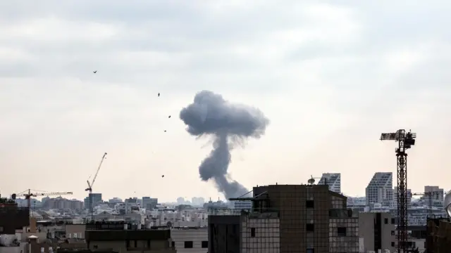 Smoke can be seen during a missile attack from Iran on Israel