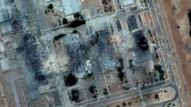 A satellite image shows a heavily damaged industrial site