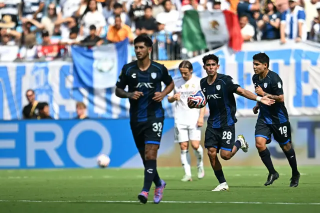 Pachuca players carry the ball back to the centre circle after scoring their first goal against Real Madrid
