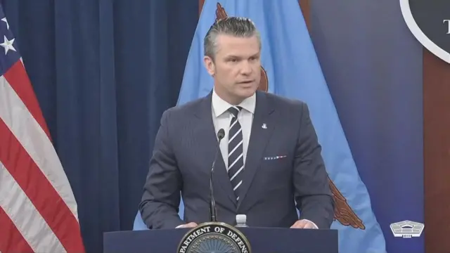 Hegseth delivers a statement behind a podium.
