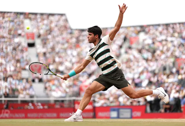 Carlos Alcaraz hits the tennis ball on Andy Murray Arena at Queen's