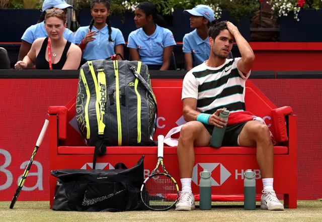 Carlos Alcaraz sits on his bench