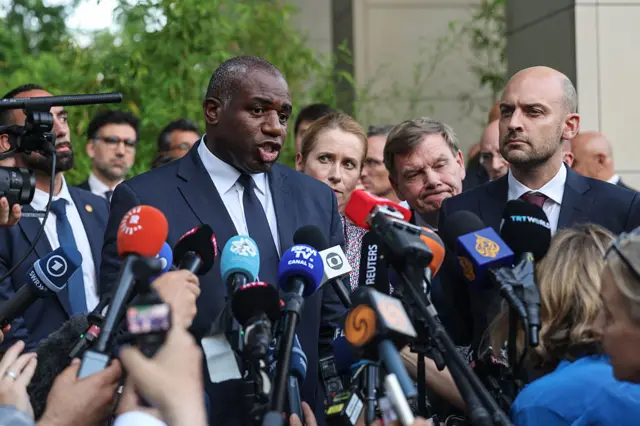 David Lammy and other european foreing ministers stand in front of a crowd of microphones.