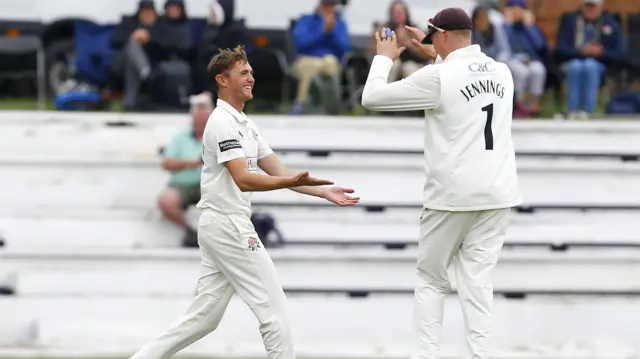 George Balderson of Lancashire County Cricket Club celebrates taking the wicket of Tawanda Muyeye