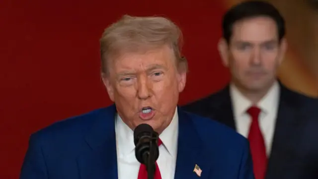 Donald Trump speaks at a podium