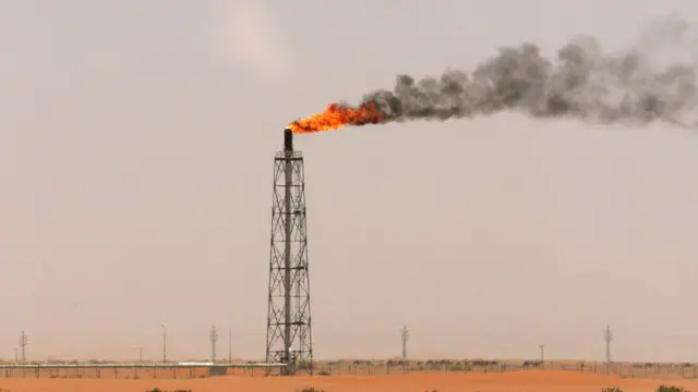 A gas flame is seen in the desert near the Khurais oilfield