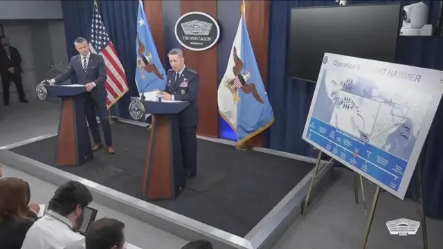 US defence secretary Pete Hegseth (L) and Chairman of the Joint Chiefs of Staff, Dan Caine stand behind podiums during a press conference.