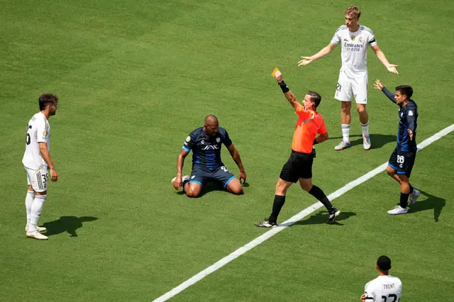 The referee shows Asencio a red card