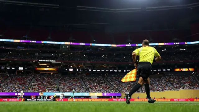 Assistant Referee Mokrane Gourari runs the line during the Club World Cup group G match between Manchester City and Al Ain