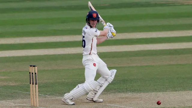 Charlie Allison striking a boundary during his century for Essex against Hampshire