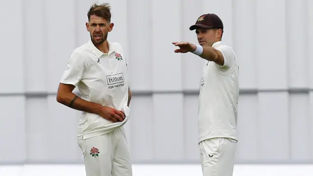 James Anderson discussing field placings with Lancashire bowler Tom Bailey