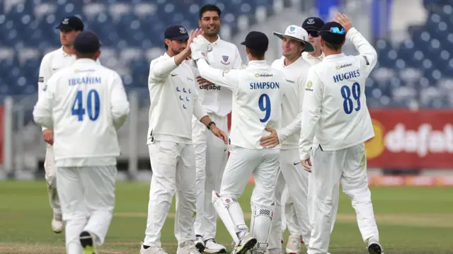 Sussex celebrate Gurinder Sandhu's first wicket for the club