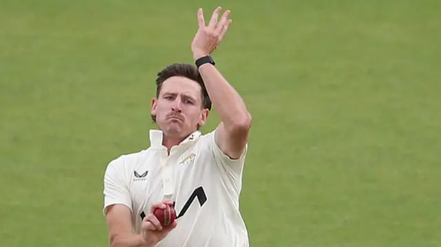 Nathan Smith bowling for Surrey