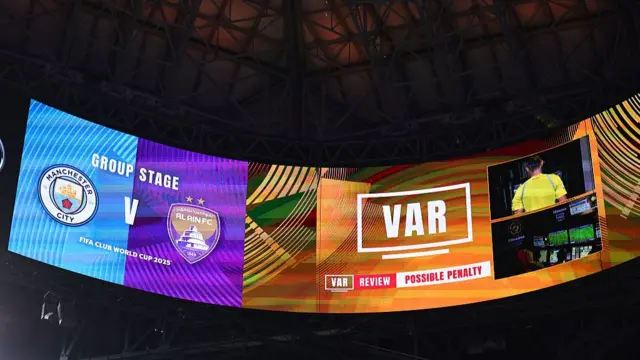 A VAR penalty review is shown on the big screen