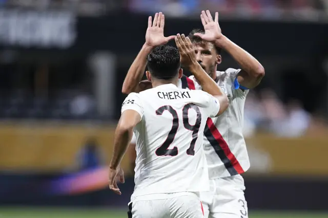 Rayan Cherki briefly celebrates scoring