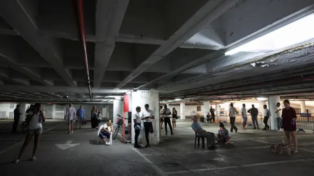 People take shelter in an underground parking lot, amid the Iran-Israel conflict