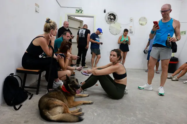 People gather in a underground shelter in Tel Aviv on June 23, 2025,