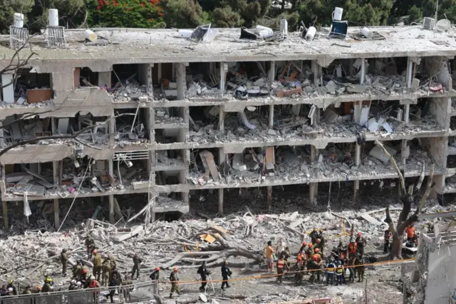 Israeli emergency teams at the scene of an Iranian missile strike on a residential building complex