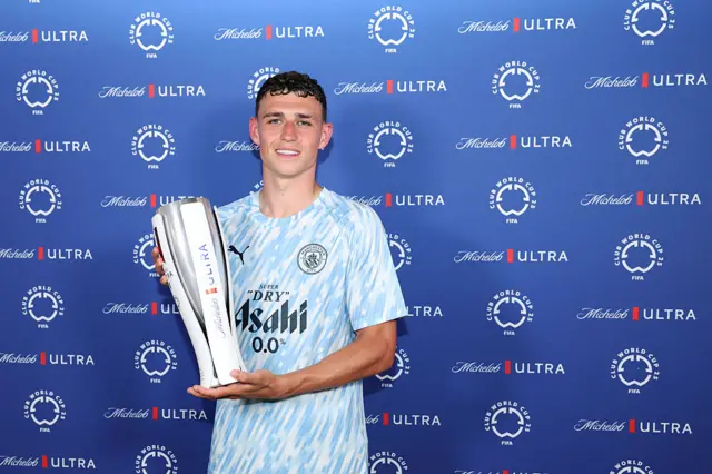 Phil Foden poses for a photo with the Superior Player of the Match trophy