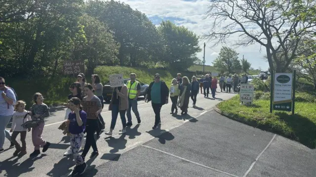 A "slow march" through Llanbedr in May 2024