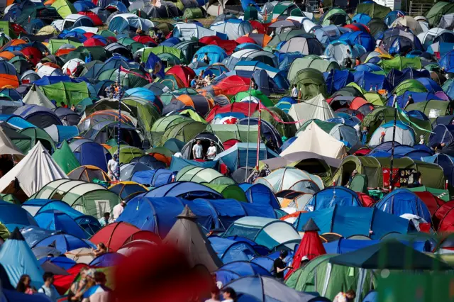 Hundreds of tents shown at the festival. They are all multicoloured and no grass is visible.