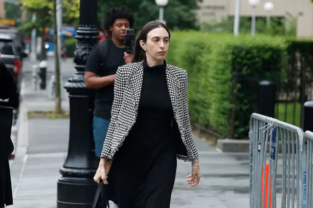Teny R. Geragos arrives to federal courthouse. She is wearing a checkered black and white blazer over a turtleneck dress