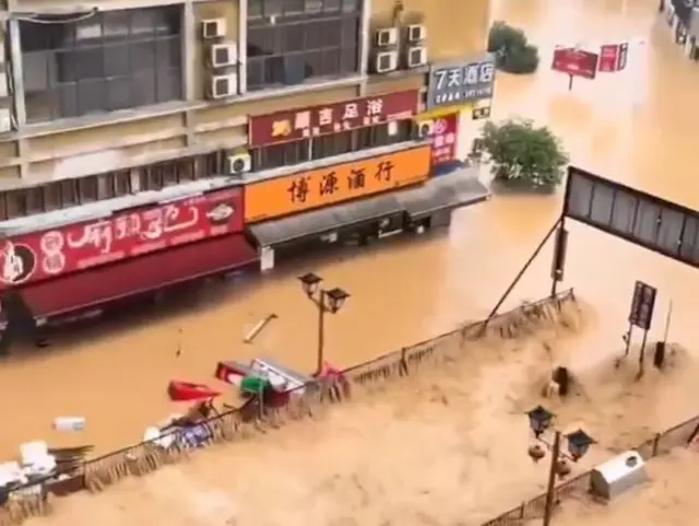 A screengrab from one of the videos showing extensive flooding on a street in Rongjiang