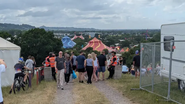 People on Tuesday were arriving at the caravan area to start setting up ahead of gates opening. The site has a beautiful view of Glastonbury's main fields and the tor in the background.